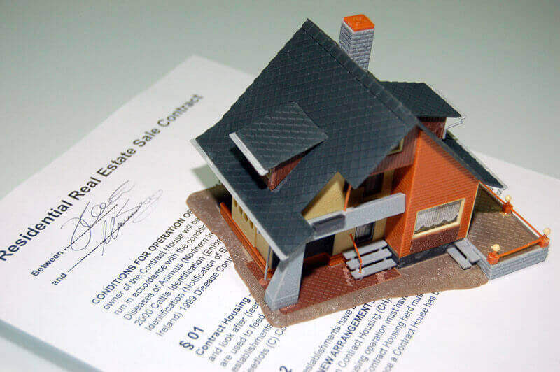 Real Estate Contract with a house on top