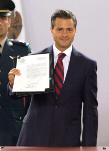 A man in a suit and tie holds up a document with text, displaying it to the camera. Another person in a military uniform is partially visible behind him. They are both standing against a light-colored background, showcasing the intersection of fintech and traditional sectors.