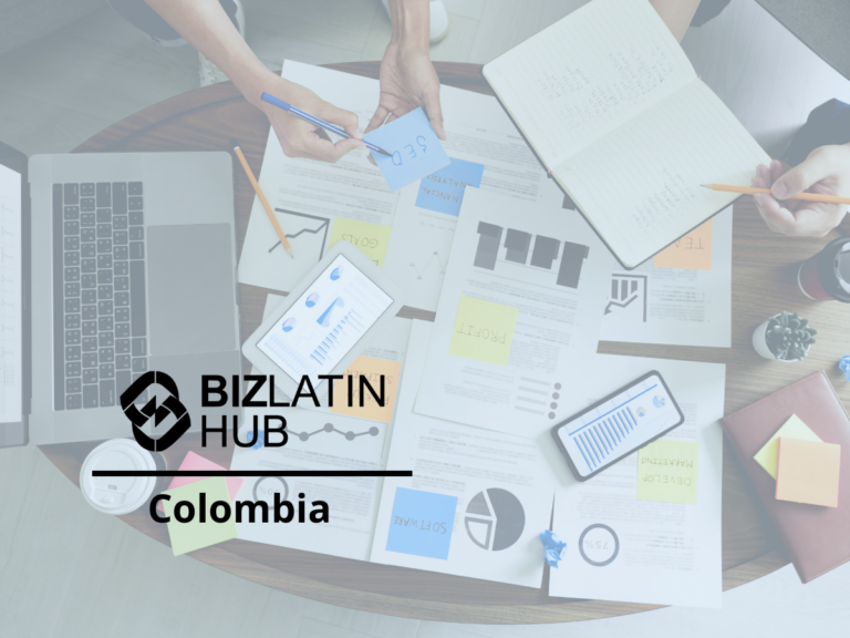 A table with business documents, a laptop, and various charts. Two people's hands are working, one holding a pen and the other a sticky note marked "Success." The logo "BizLatin Hub Colombia" is present at the bottom left corner, emphasizing services to incorporate a company in Colombia.