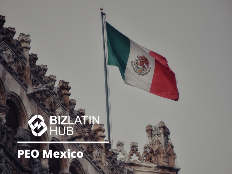 The image shows the Mexican flag flying atop a decorative building with intricate stonework. The text "BizLatin Hub PEO Mexico" appears in the lower-left corner beside a circular emblem, highlighting their role as a professional employer organization in Mexico. The sky in the background appears overcast.