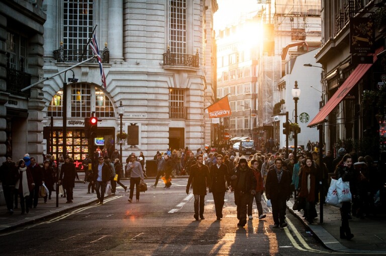 A group of people walking on a street, bustling with energy, reflecting the vibrant business growth in Latin America.