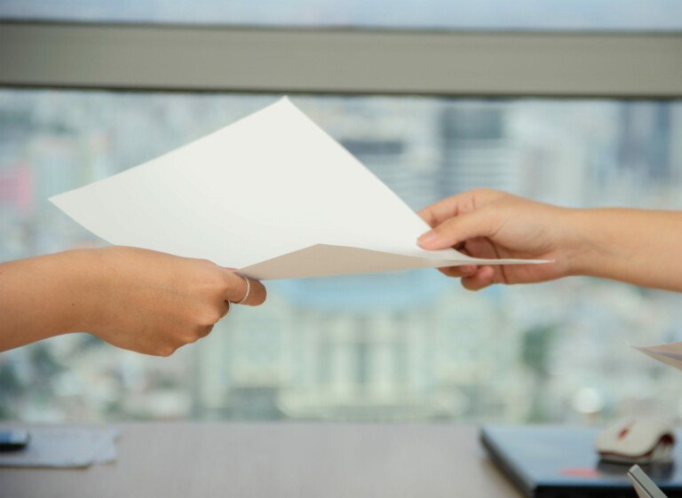 People exchanging a paper about Ecuador Accounting and tax compliance