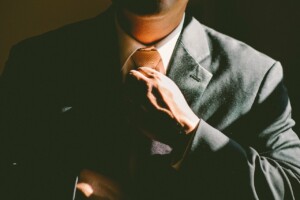 Businessman adjusting tie