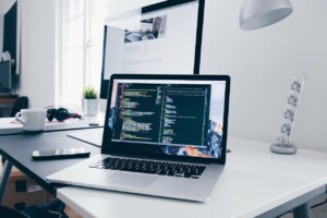 Laptop sitting on a desk which is displaying a code.