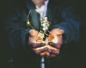 Man holding light bulb in his hands.