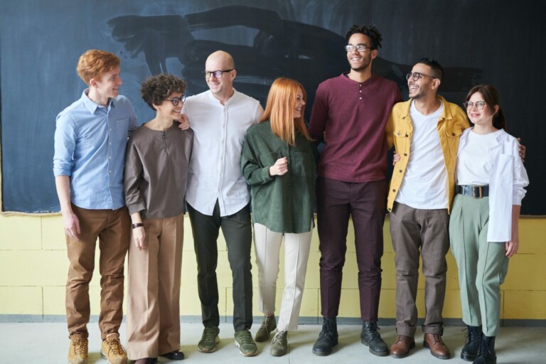 Group of people standing in front of a chalkboard