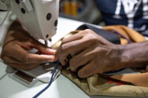 Person using a sewing machine in the Guatemala textile industry