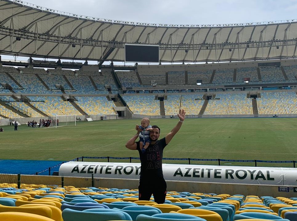 Julián Arrayago, Biz Latin Hub’s Corporate Accountant in Chile with his son in a soccer stadium.
