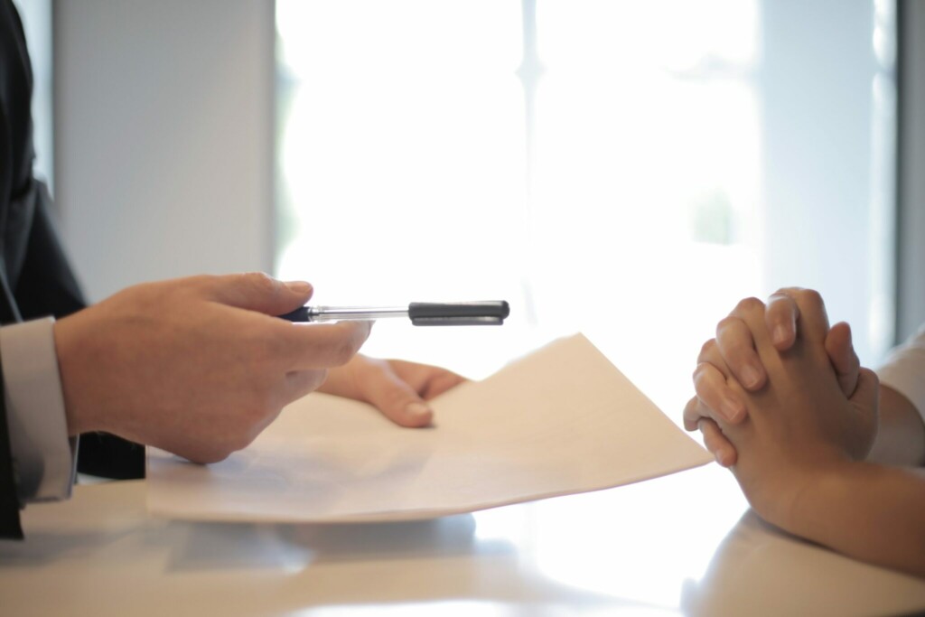 Two men agreeing and shaking hands after signing the constitution.