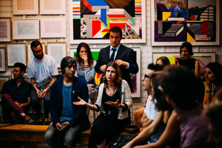 Woman explaining Guatemala business etiquette to a group of people