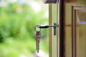 Door to a home with key in lock