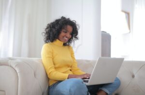 Woman using her laptop to work from home, as teleworking is one of the measures implented during Covid-19 outbreak in Ecuador.