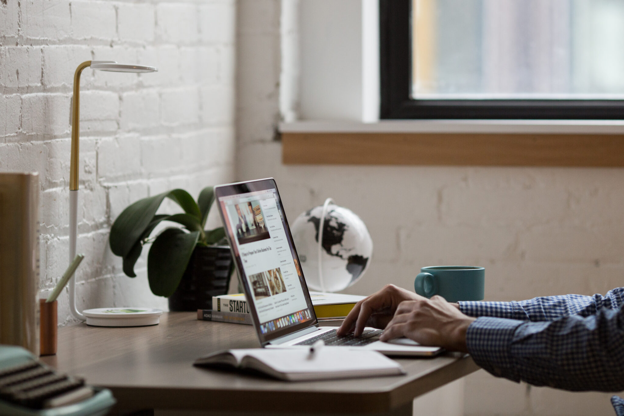 Person working at a desk with a laptop