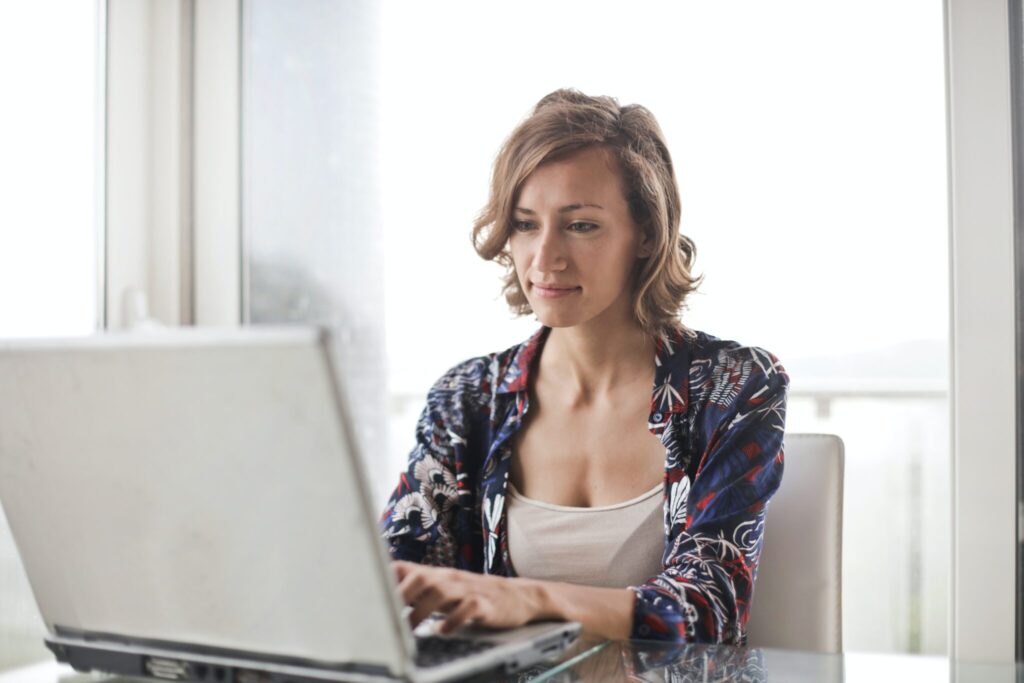 Woman at home using her computer to search information about challenges of doing business in Mexico. 