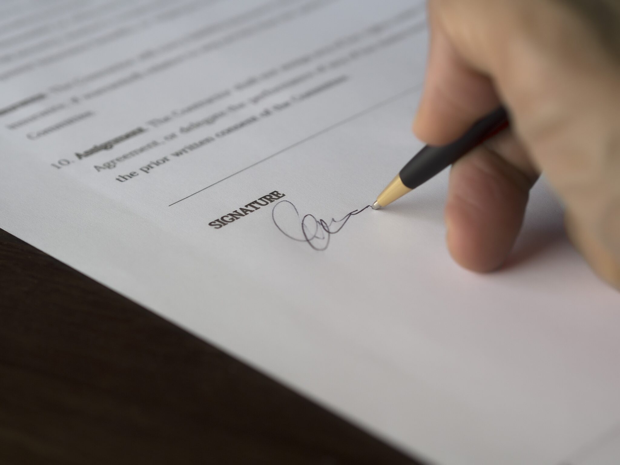 Homem assinando um documento