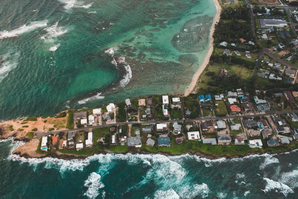 Aerial shot of houses on an island, representing the properties available for those interested in buying property in Guatemala. 