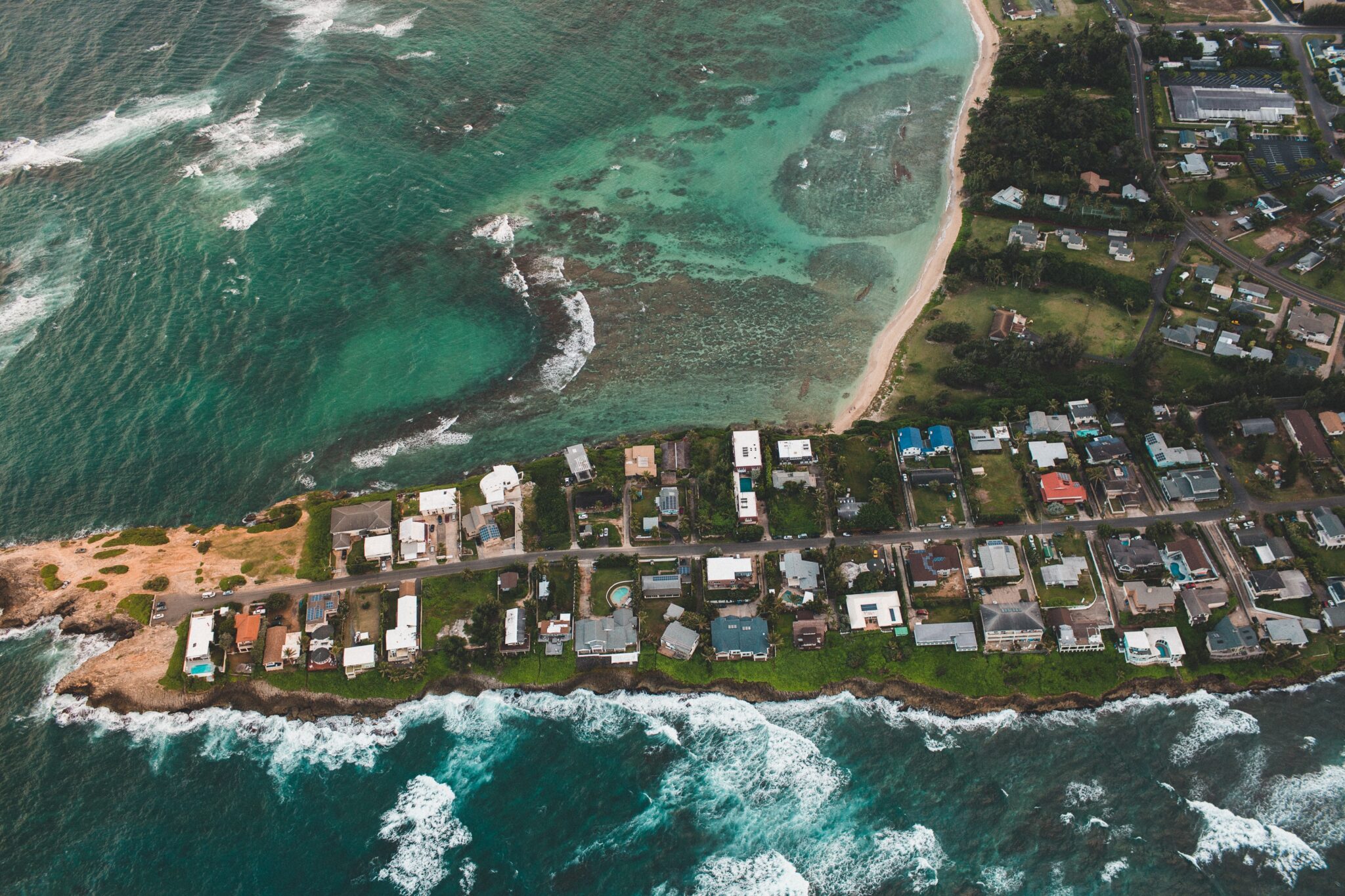 Aerial shot of houses on an island, representing the properties available for those interested in buying property in Guatemala.