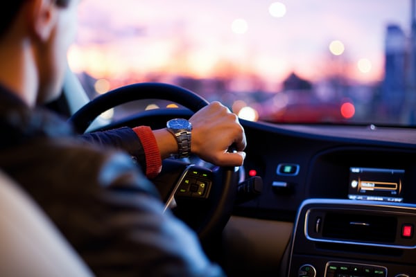 A photo of a man driving a car, representing someone whose driving record will be probed as part of background checks in Peru because their potential role warrants it