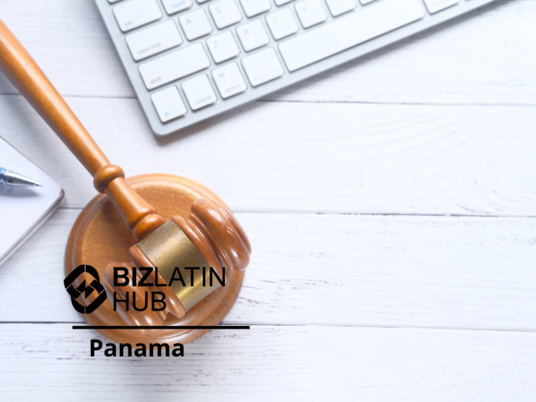 A wooden gavel and base are placed on a white wooden surface beside a keyboard. A notebook and pen are partially visible on the left. The text "BIZLATIN HUB Panama," representing a legal firm in Panama, is displayed on the image.