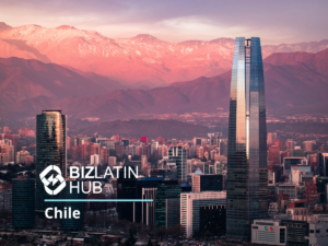 A cityscape view of Santiago, Chile, featuring modern skyscrapers with mountainous terrain in the background during sunset. The BizLatin Hub logo and the text "IT Recruitment in Chile" are overlaid on the image in the foreground.