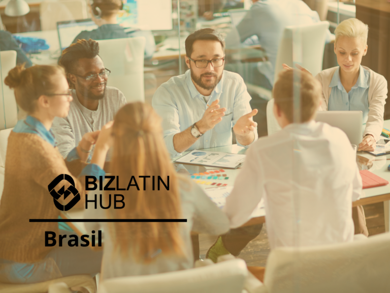 A group of six people sit around a table in an office, engaging in a discussion. The table is covered with papers and laptops. In the foreground, the logo "BIZLATIN HUB" and the word "Brasil" are visible, highlighting their focus on nearshoring in Brazil.