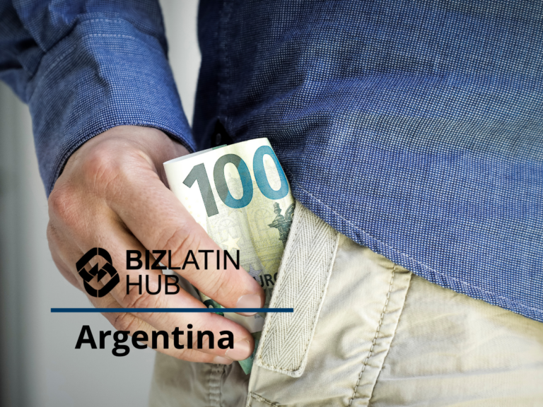 A person wearing a blue shirt and beige pants is placing a rolled-up 100 Argentine peso bill into their pants pocket, symbolizing the impact of inflation in Argentina. The image features a Biz Latin Hub logo with "Argentina" written below it.