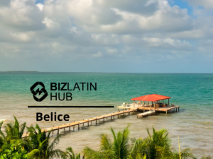 A view of a wooden pier extending into clear turquoise waters under a partly cloudy sky, with palm trees in the foreground. The text overlay reads "Biz Latin Hub Belice" with a stylized logo on the left, highlighting Estrategias Fiscales Belice.