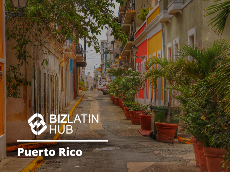 A narrow street in Puerto Rico lined with vibrant buildings, potted plants, and greenery. The Biz Latin Hub logo and text, emphasizing expertise in employment laws in Puerto Rico, are overlaid on the image.